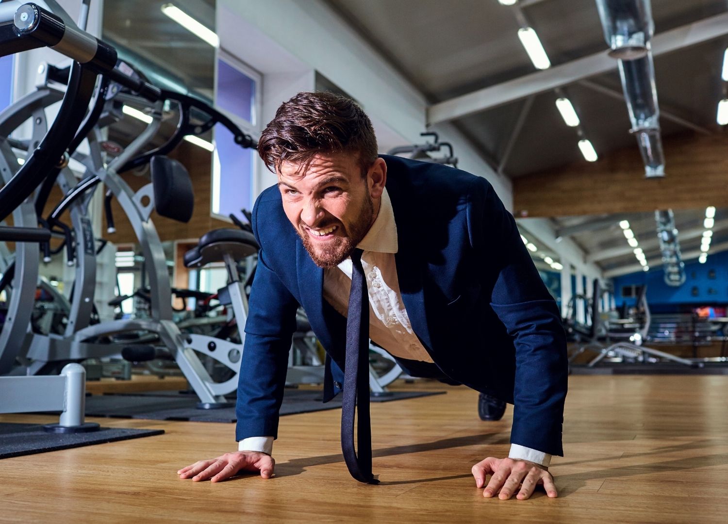Man performing push-ups in a corpoarte suit