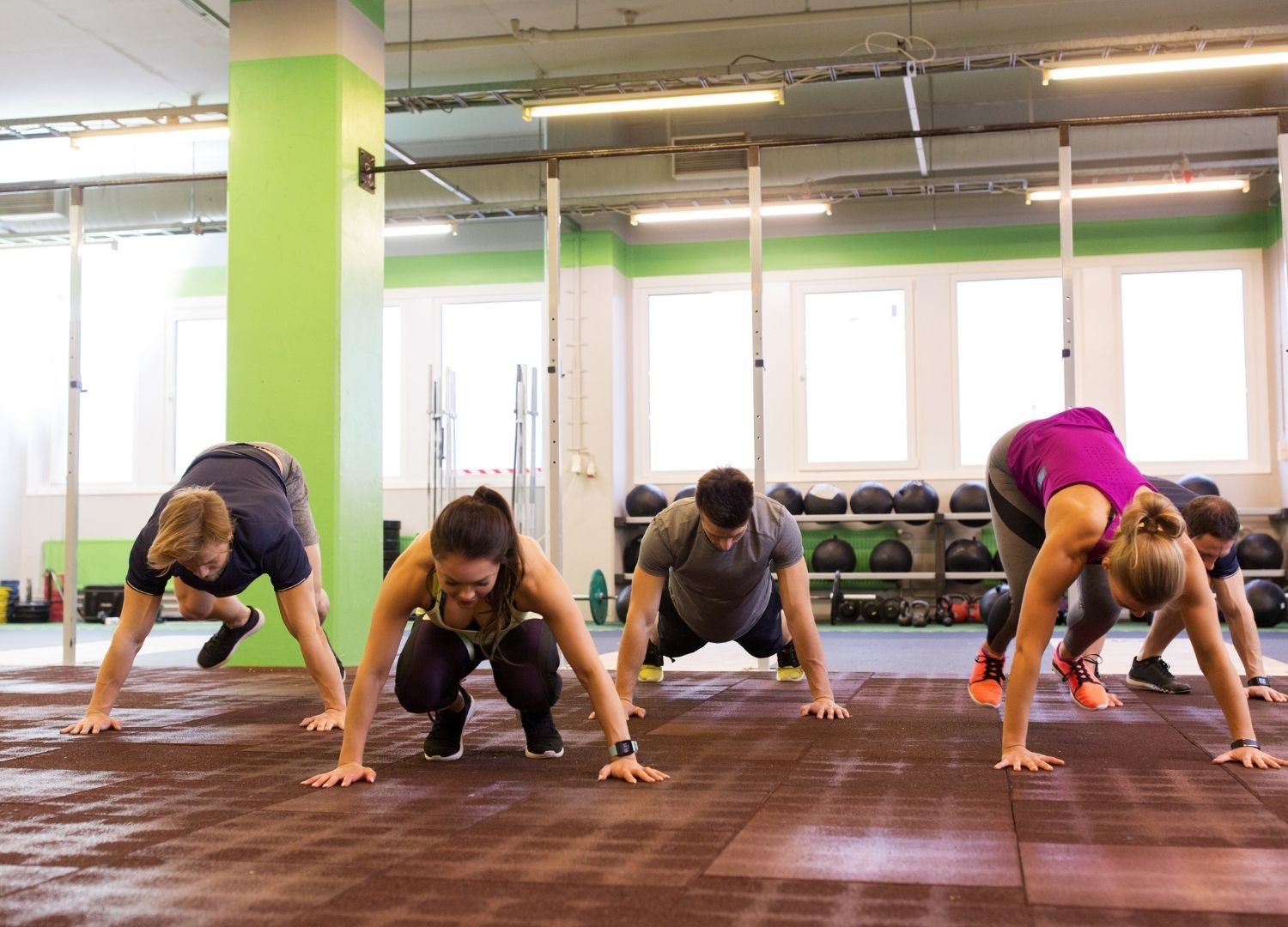 Group of people participating in 1-min burpee challenge
