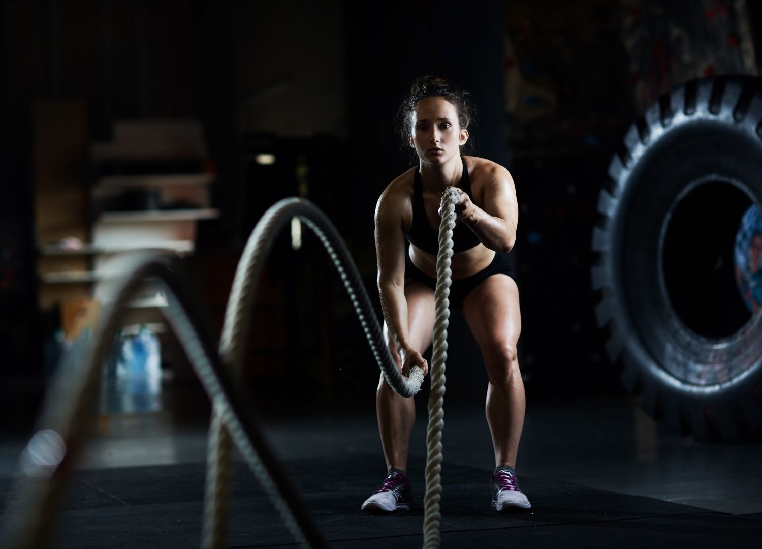 Woman performing a battle-rope exercise