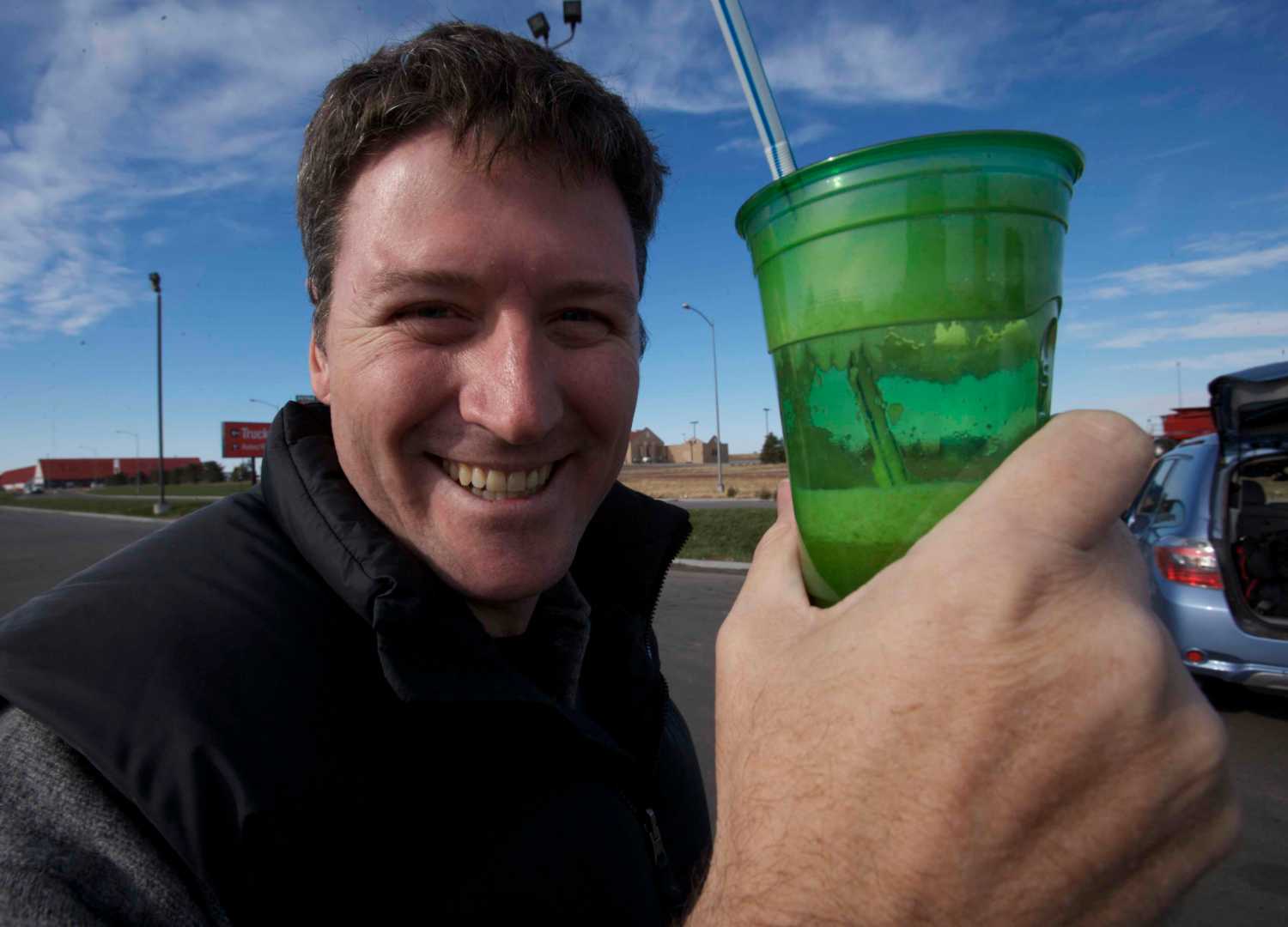 An actor from movie holding a glass of juice