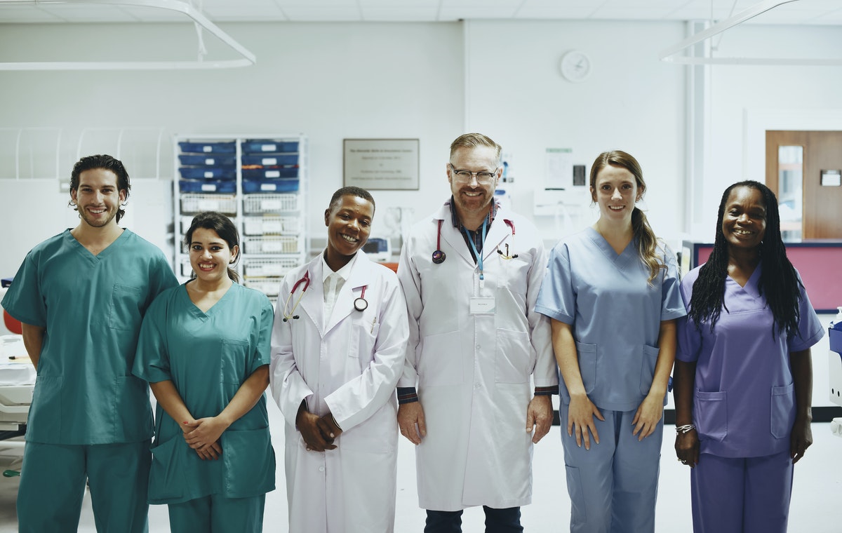Happy medical team helping patients during COVID-19