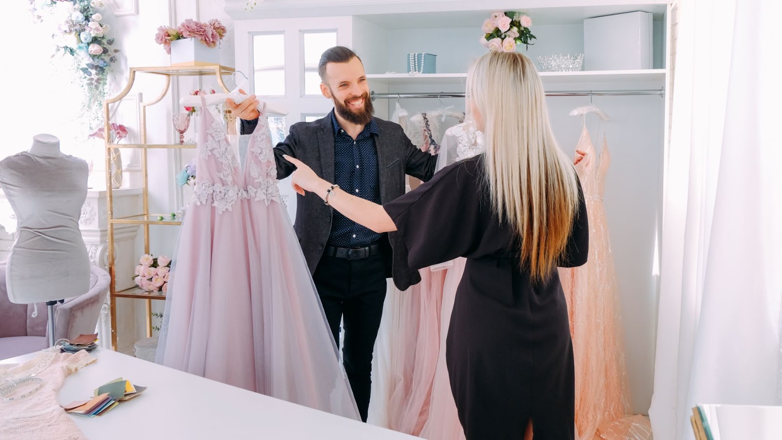 High ticket closing: Man helping woman pick out expensive gown