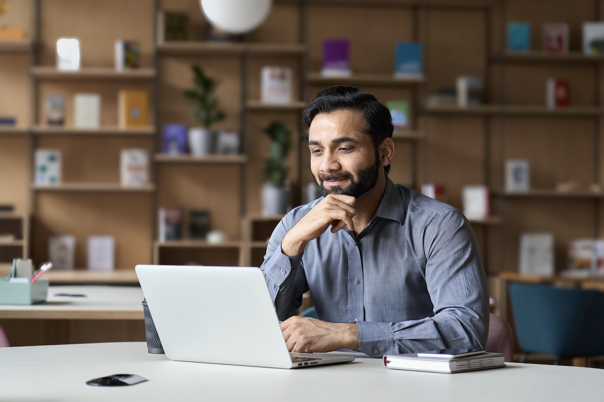 ecommerce CRO: Smiling man looking at his laptop