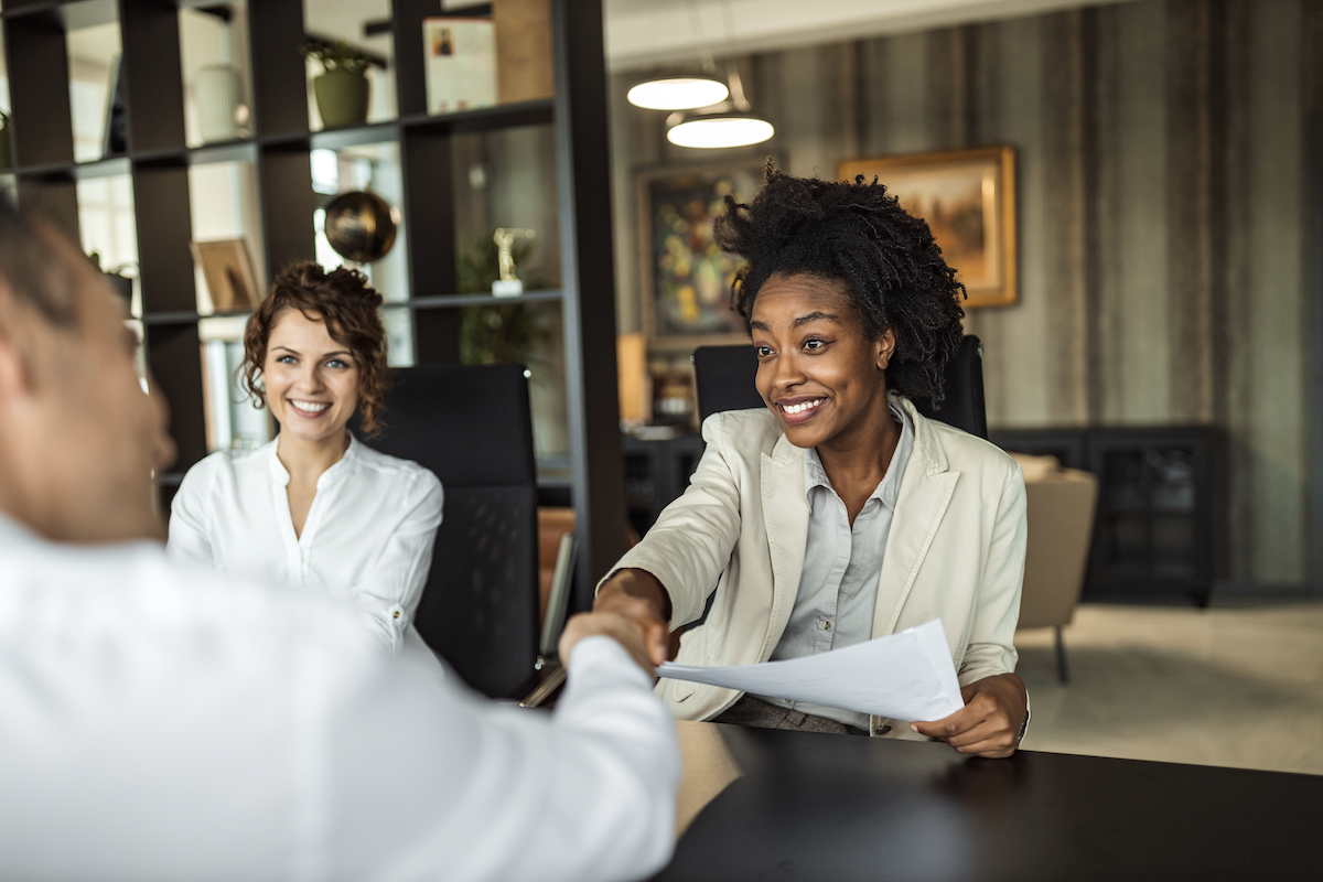 lead response: Colleagues shaking hands after a meeting