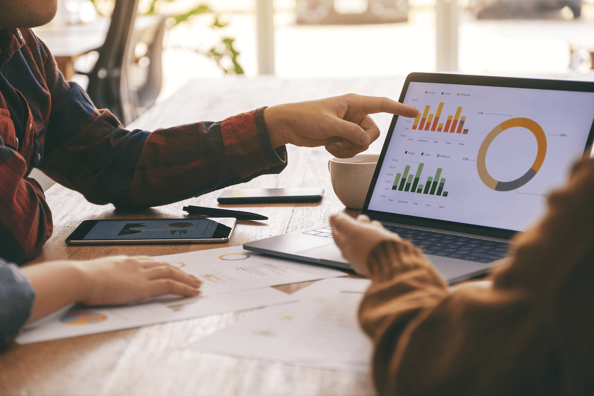 freemium business model: person pointing to graphs on a tablet