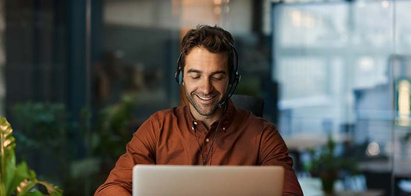 Man using softphone on laptop