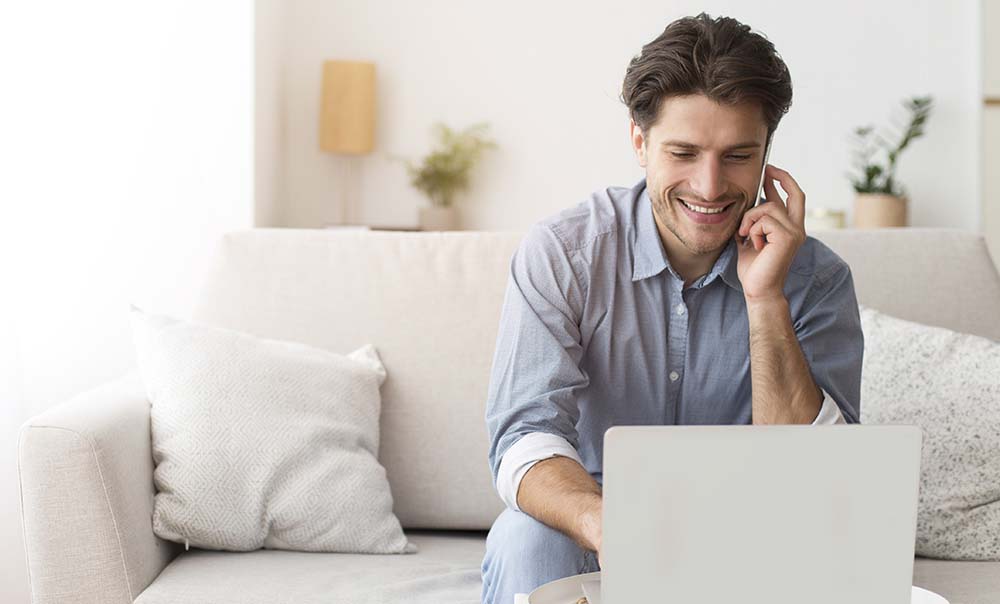 A remote worker at home using a VoIP phone