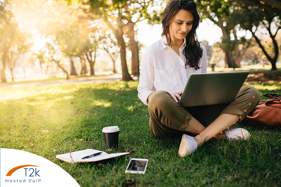 Office worker in the park using VoIP phone system