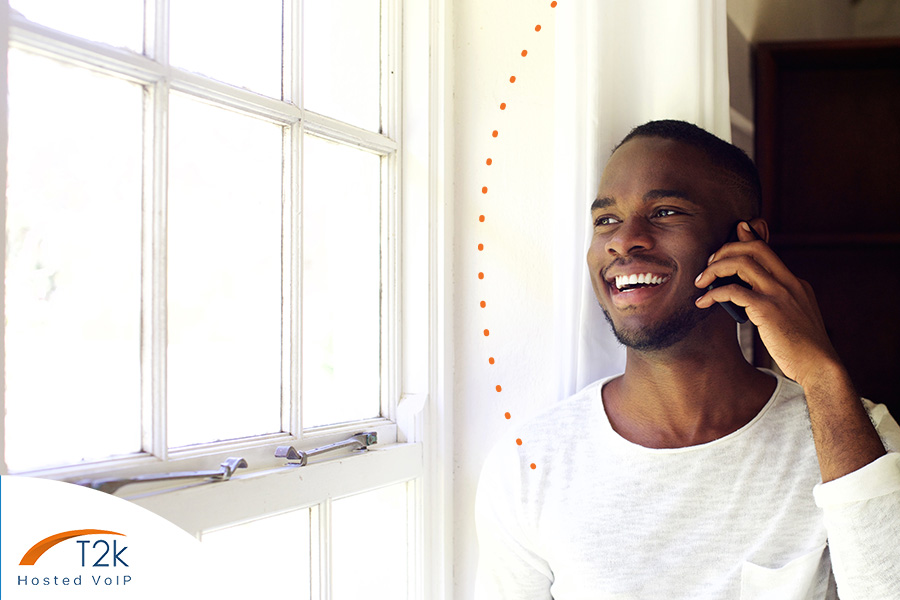 Man on the phone listening to music on hold from a voip phone system