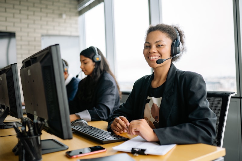 A call centre employee listening to a call whisper before receiving a customer call
