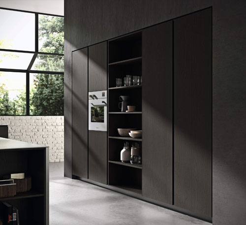Cucina con maniglie a gola e e colonne contenitive con frontali in olmo verniciato nero