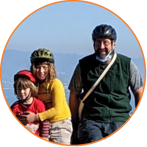 Zach and boys smiling while wearing bike helmets