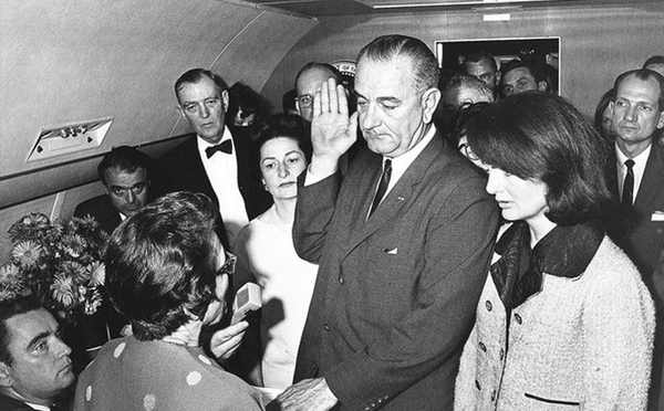 Lyndon B. Johnson takes the Oath of Office aboard Air Force One
