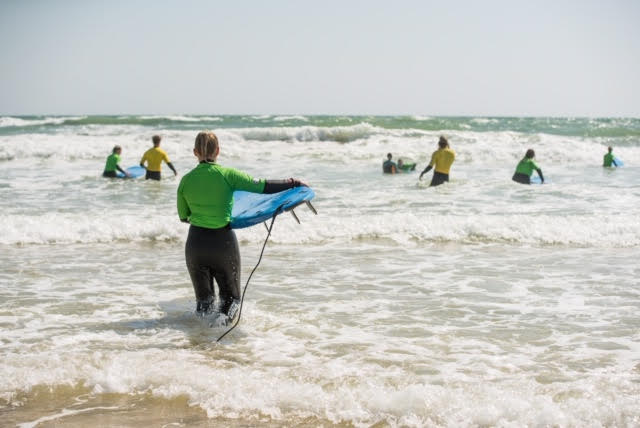Heading out to sea with the group to try surfing for the first time