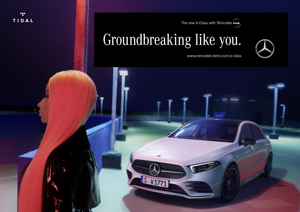 A woman with bright red hair stands in front of a Mercedes