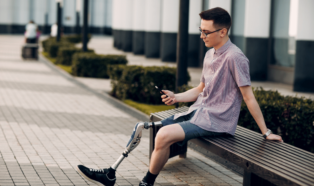 Man with Prosthetic Leg sitting in the outdoors.