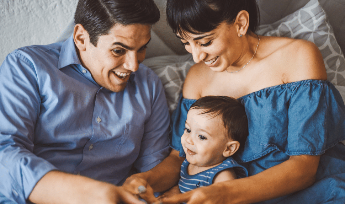 Happy family playing with their son after buying life insurance.