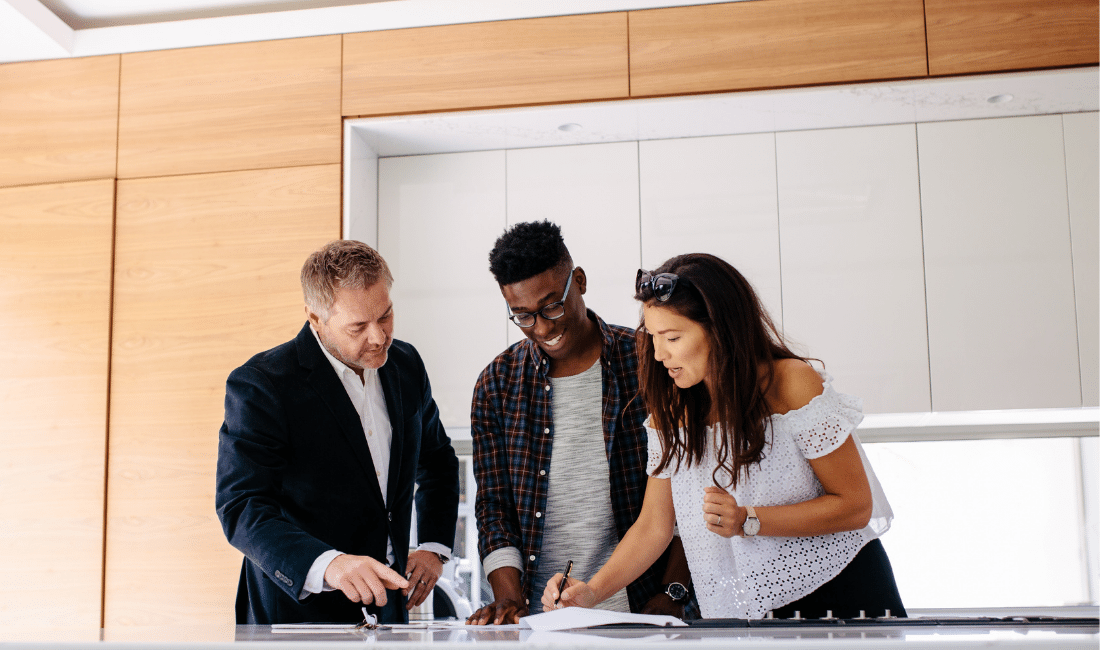 Couple with Realtor Signing Mortgage Contract