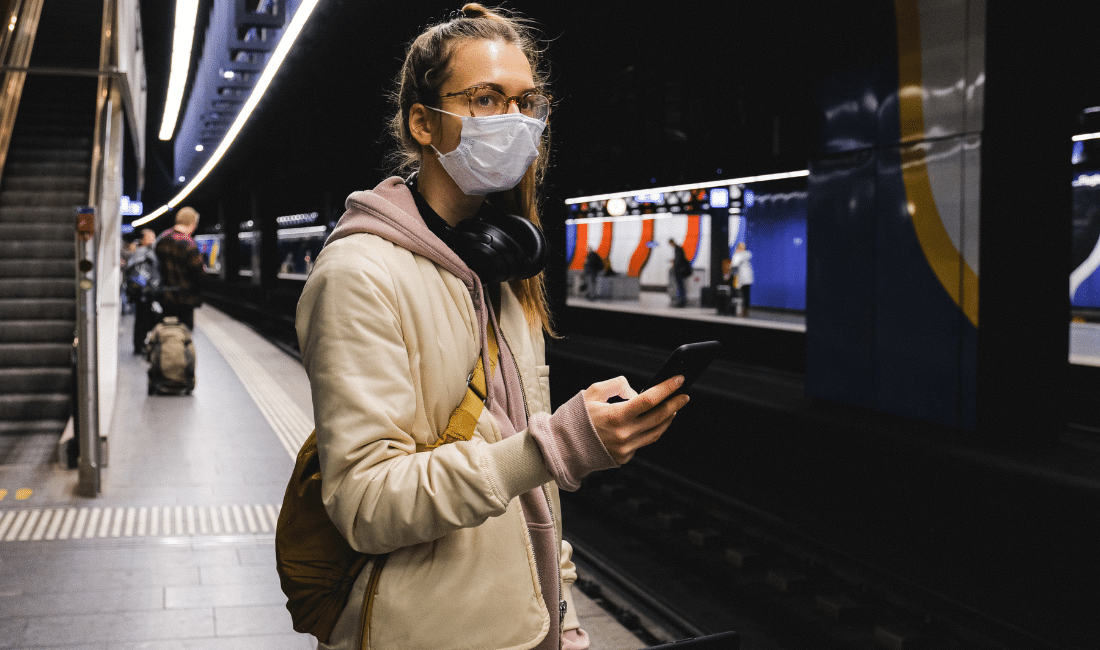 Woman With a Face Mask Standing on Train Station