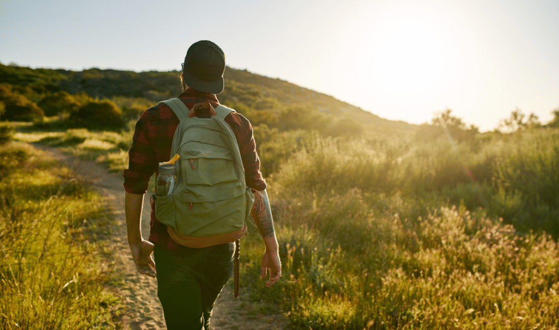 Male Millennial Hiker Walking Trail