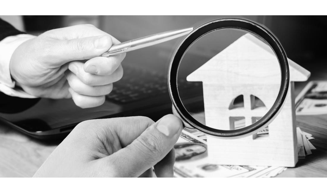 Magnifying glass on wooden home