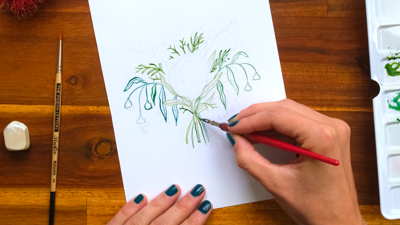 A top down photo of an artist drawing Australian leaves with a nib