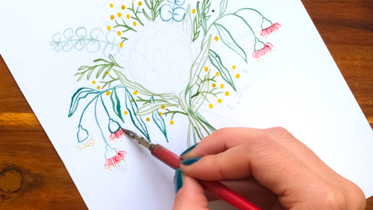 Artist's hand drawing silver princess blossoms with a nib and watercolours