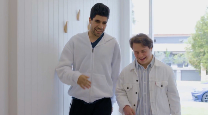 Image of two residents walking through the corridor of their new home