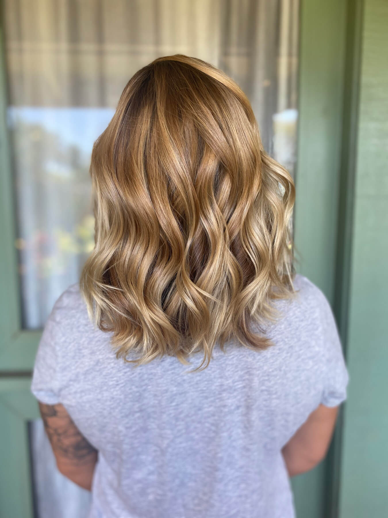 Beautiful curled blonde partial balayage