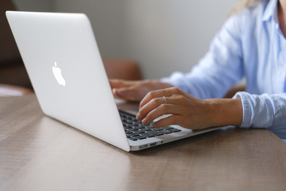 retail manager sending out retail communications on laptop