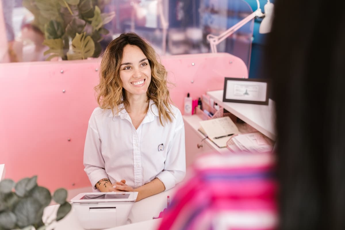 beauty retail employee smiling at client