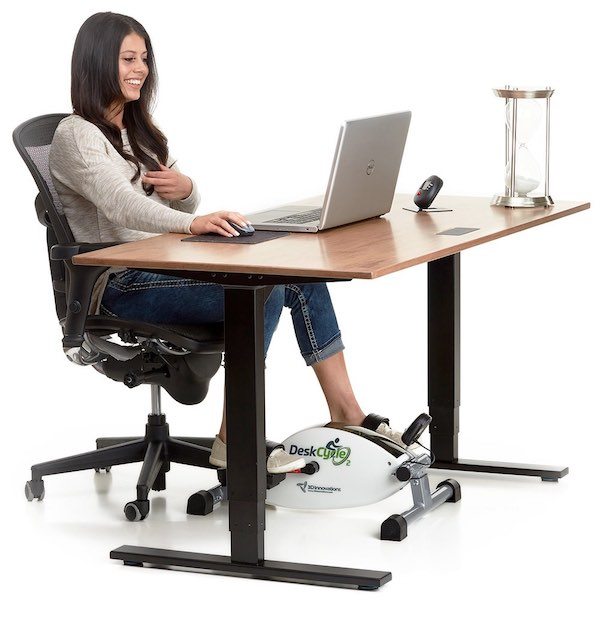 Woman using deskcycle bike at desk