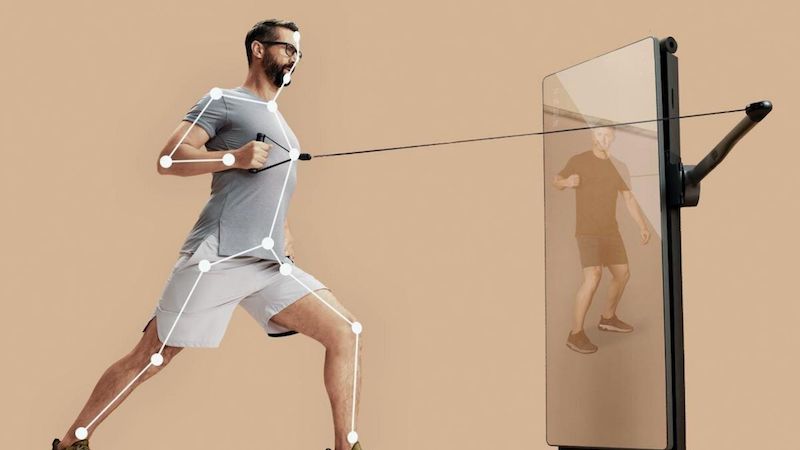 A man working out usinf. the FORME Life home smart gym.