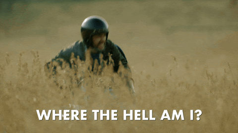 A GIF showing an man in a field standing up, wondering where he is.