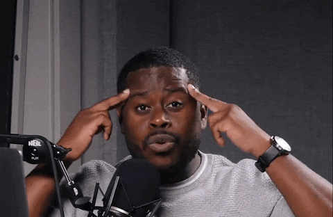 A GIF of a man pointing to his head and emphatically saying focus.