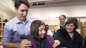 Image source: The Globe and Mail - Prime Minister Trudeau welcomes Syrian refugees in Pearson Airport on December 11, 2015.