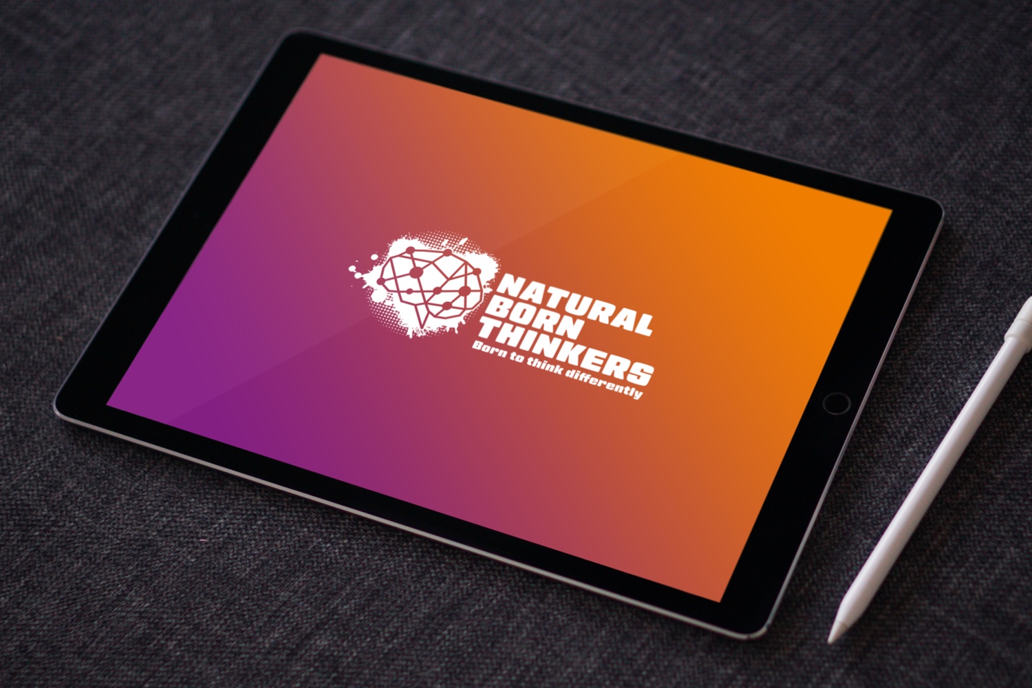 Natural Born Thinkers Logo Design on a tablet