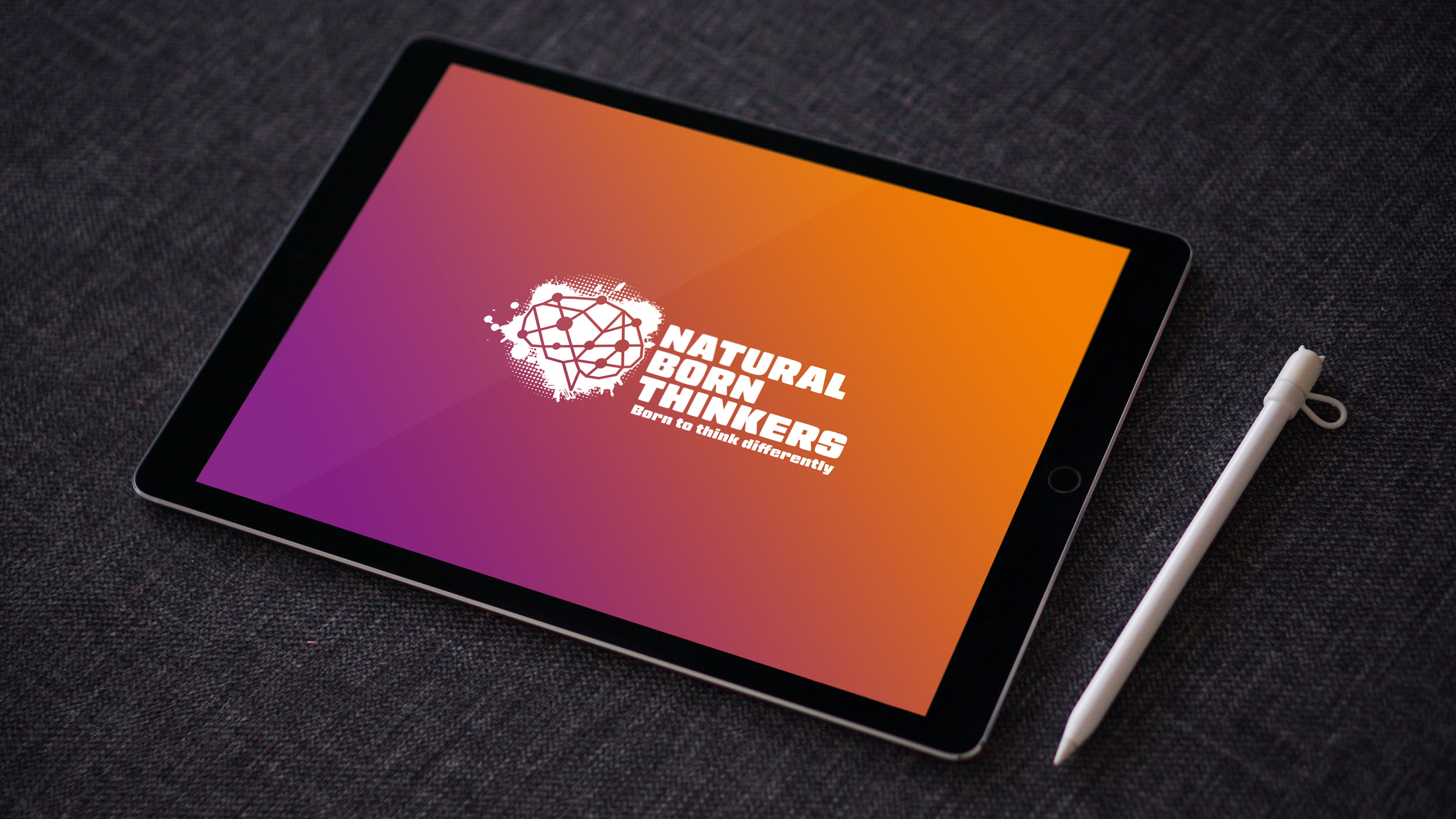 Natural born thinkers logo design on a tablet screen.
