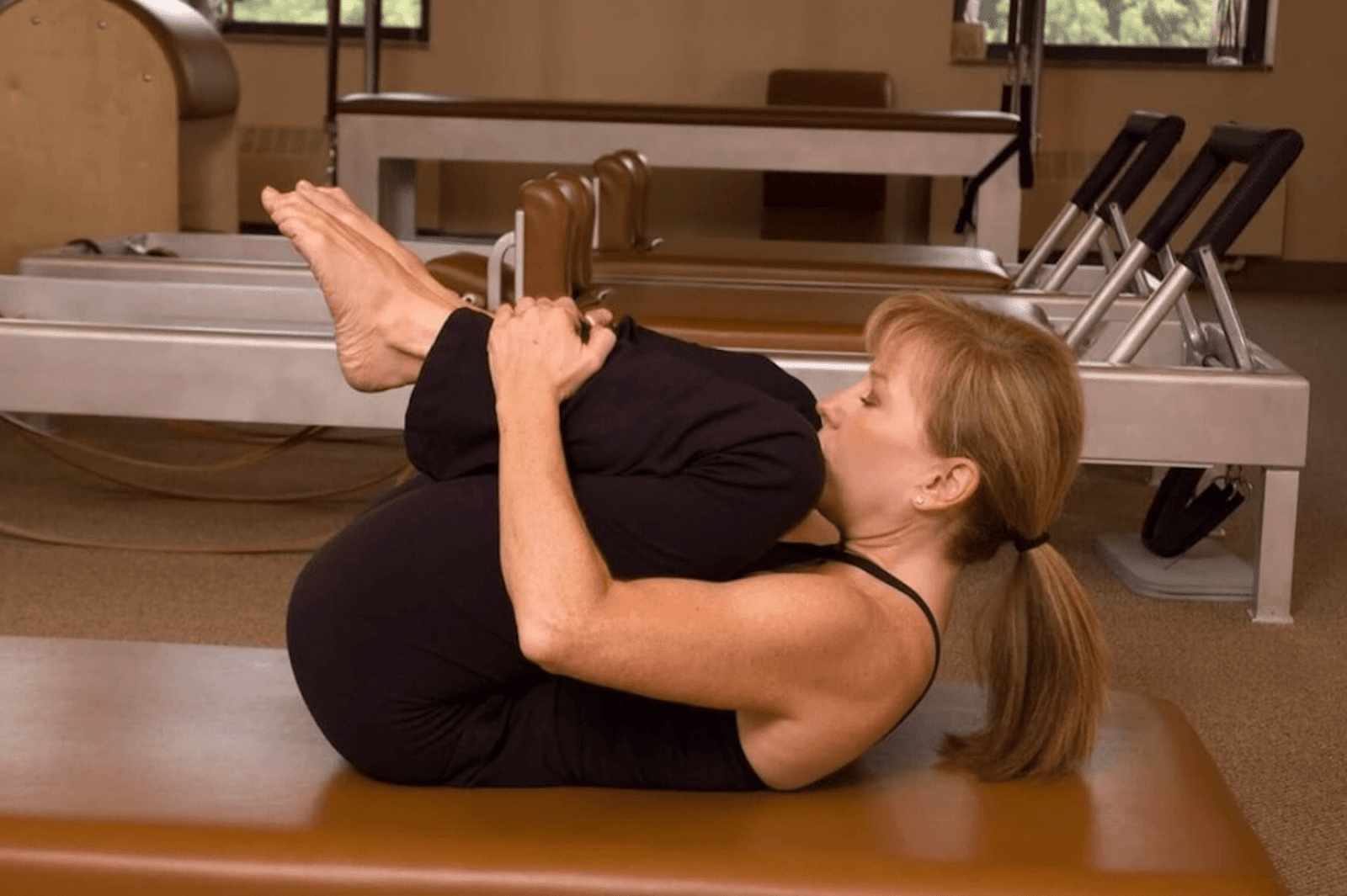woman practicing a Pilates exercise
