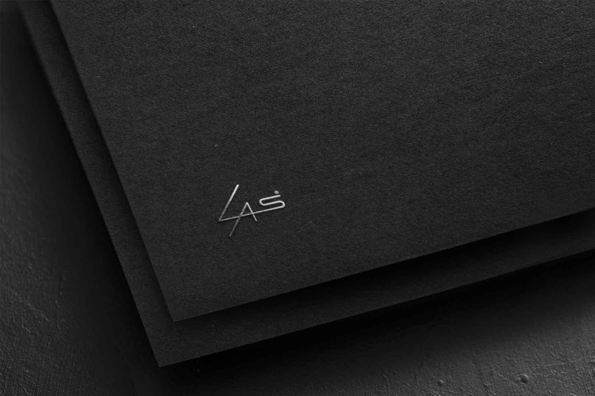 Silver LAS Design logo printed on black paper