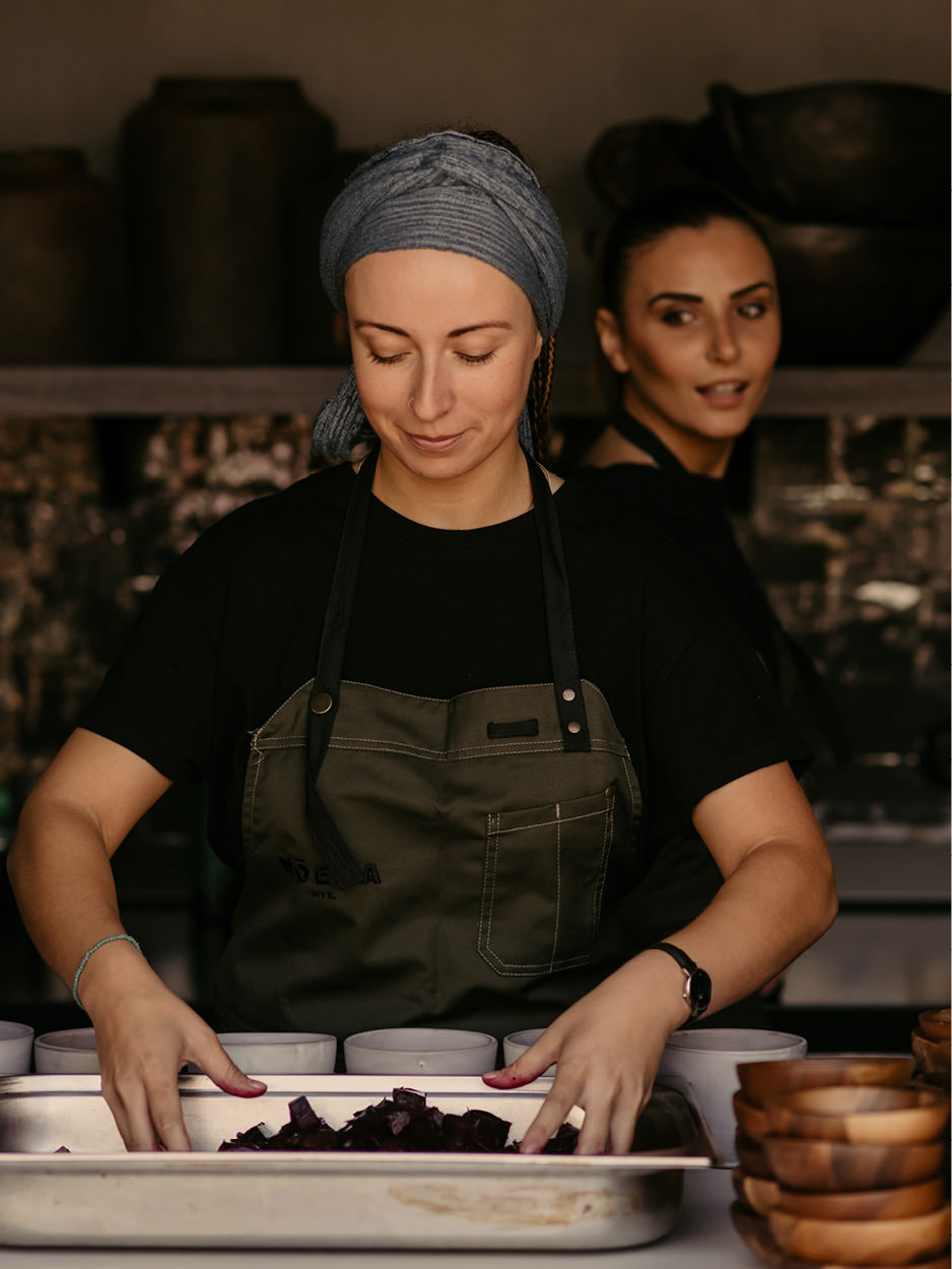 greek cuisine women cooking in a restaurant in mykonos chef noema