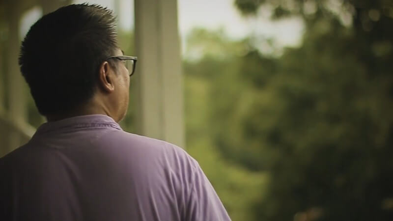 Man looking into trees while walking away from camera to show he is walking away from sexual sin