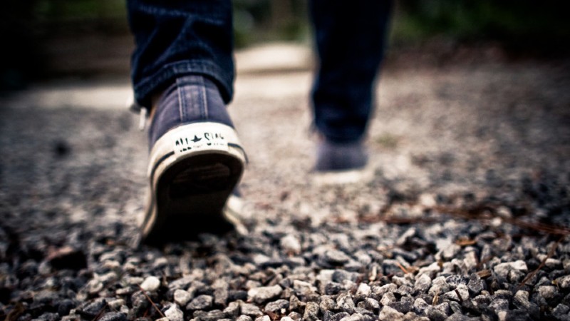 Man walking on gravel road