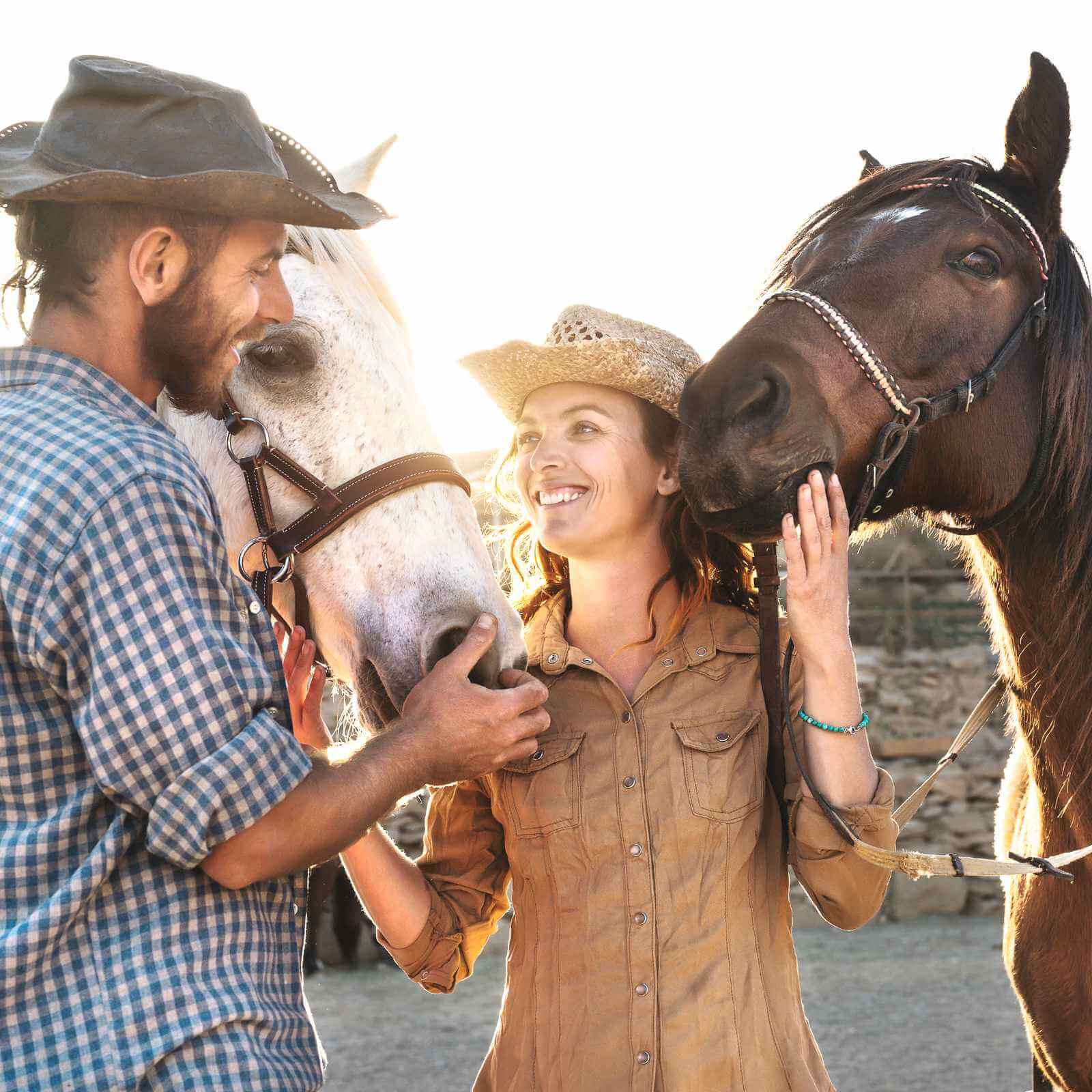 Two friends with beautiful smiles preparing to ride horses
