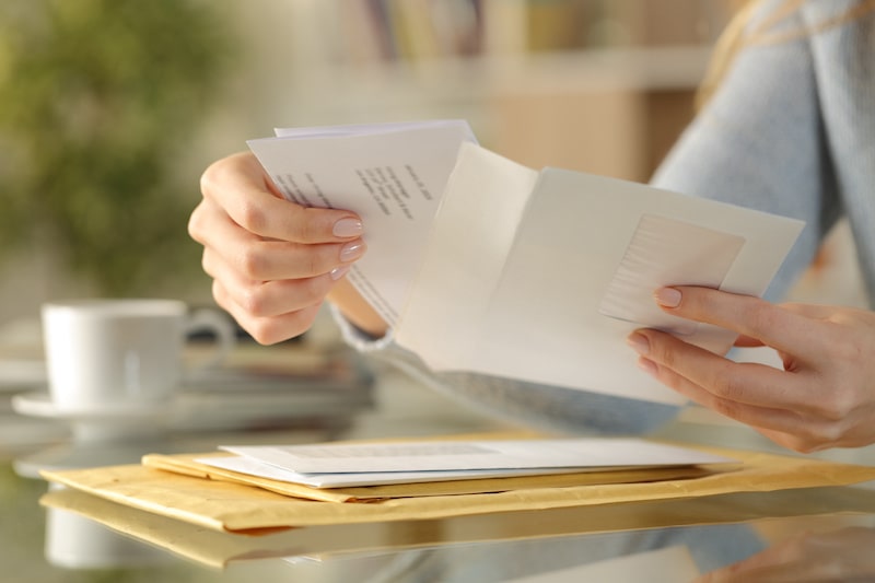 woman opening envelope