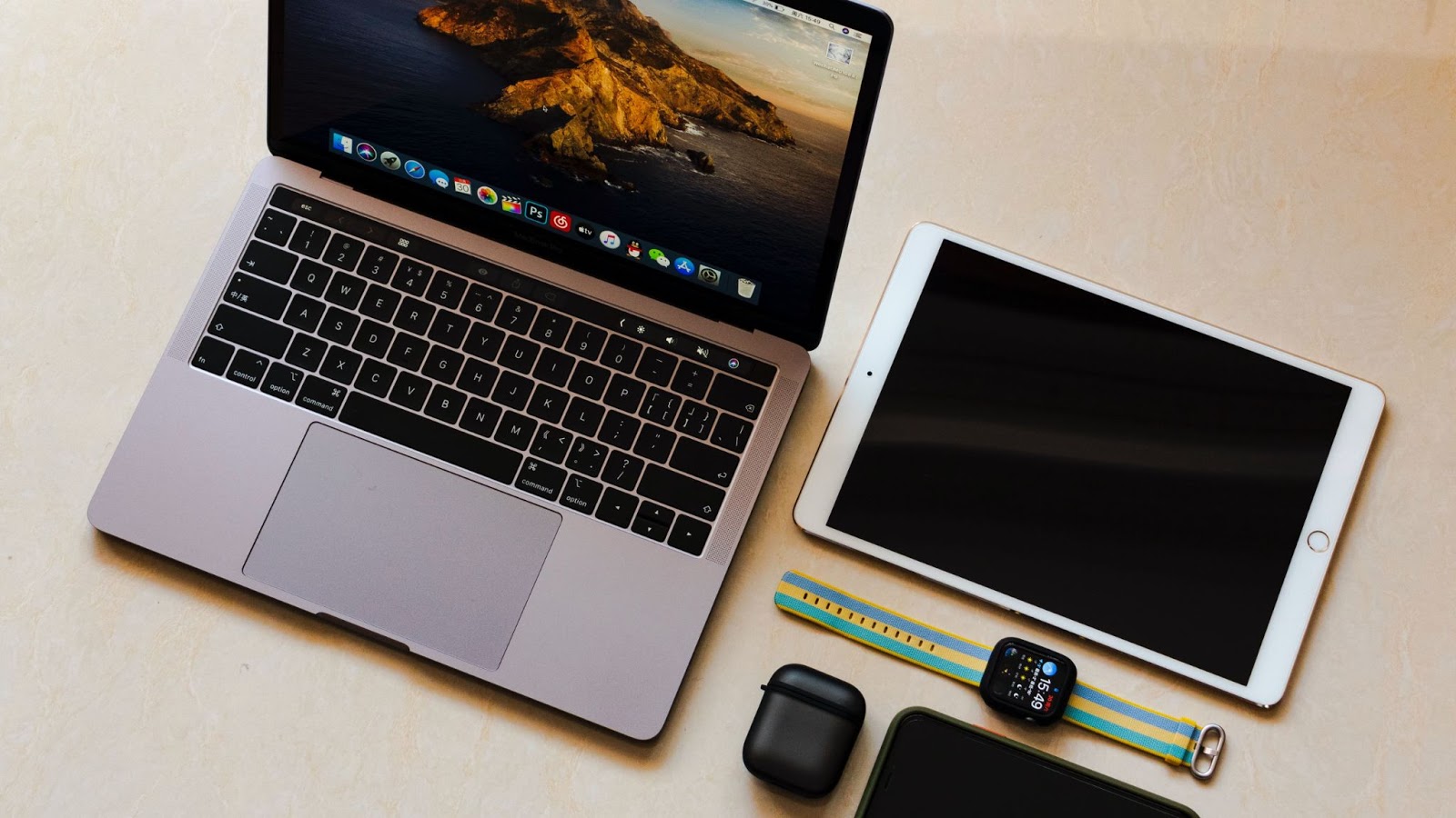 Matériel informatique et objets connectés vus du dessus, posés sur une table