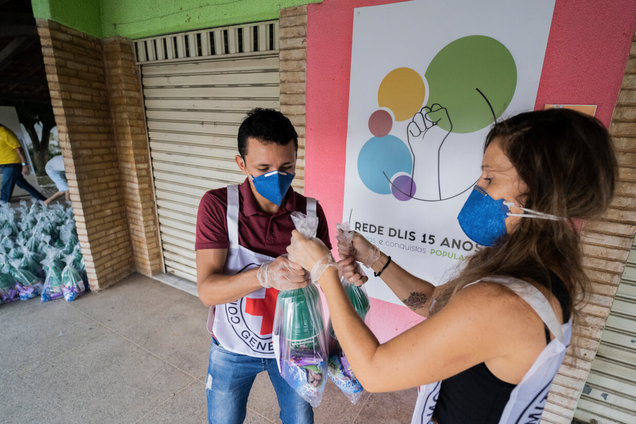 Two people preparing COVID supplies