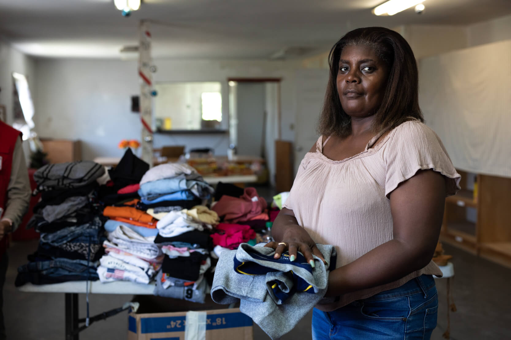 a woman folding clothes to prepare for a disaster