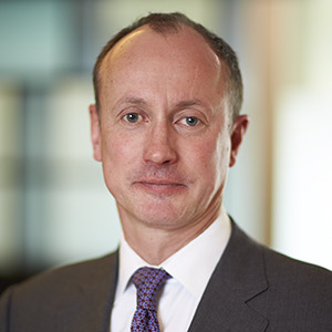 Photo of John Hutchinson, a partner at Hall & Wilcox law firm; a user of the Atticus Legal Tech verification software