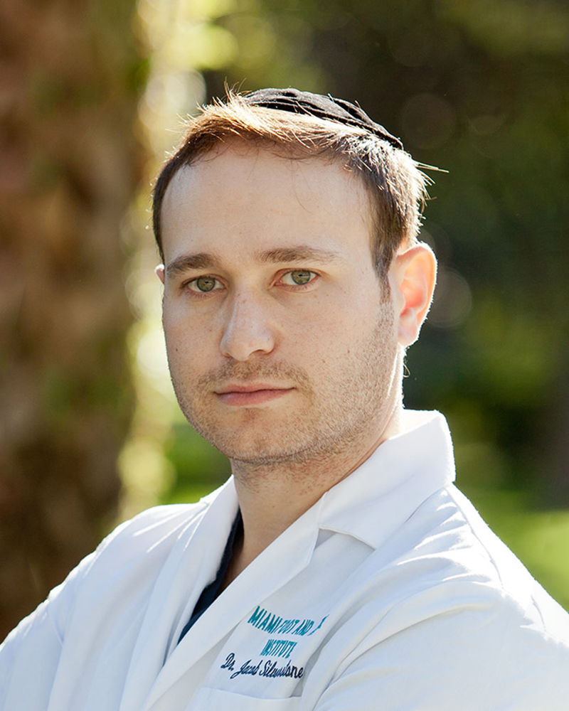 podiatric surgeon doctor Jacob M. Silverstone, D.P.M. wearing a white lab coat